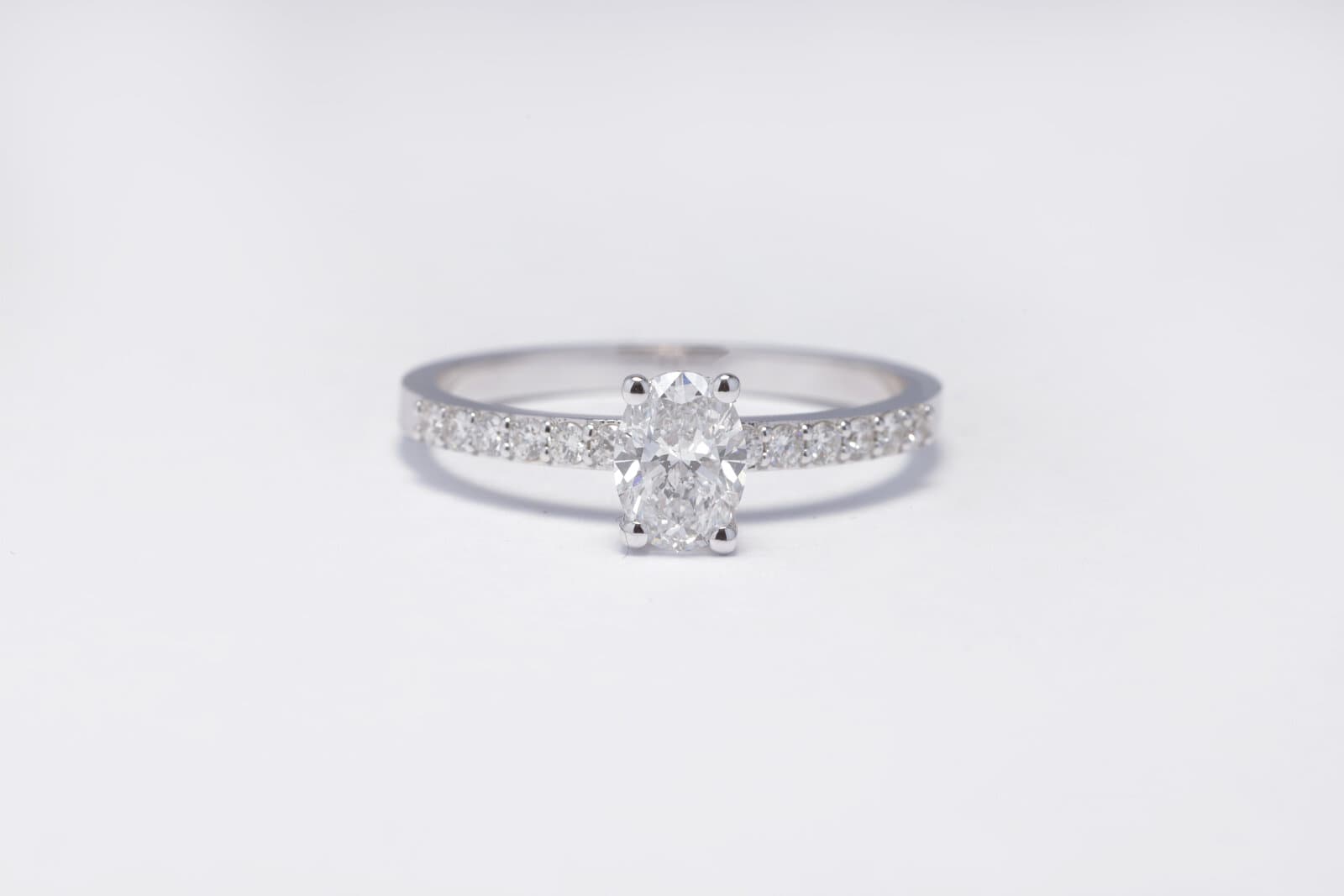 A classic solitaire ring featuring an oval diamond at the center