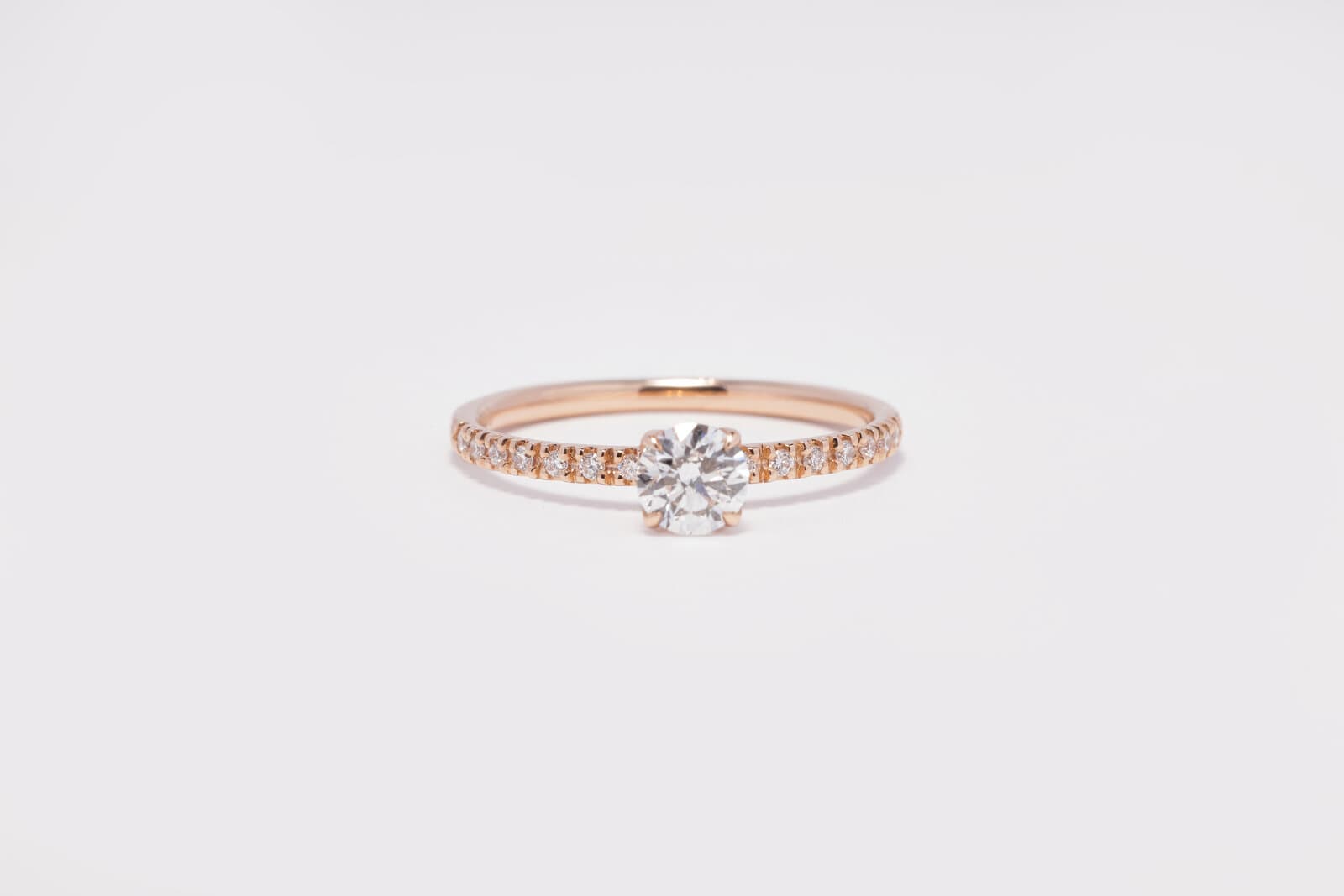 Handcrafted brilliant cut solitaire with a diamond band