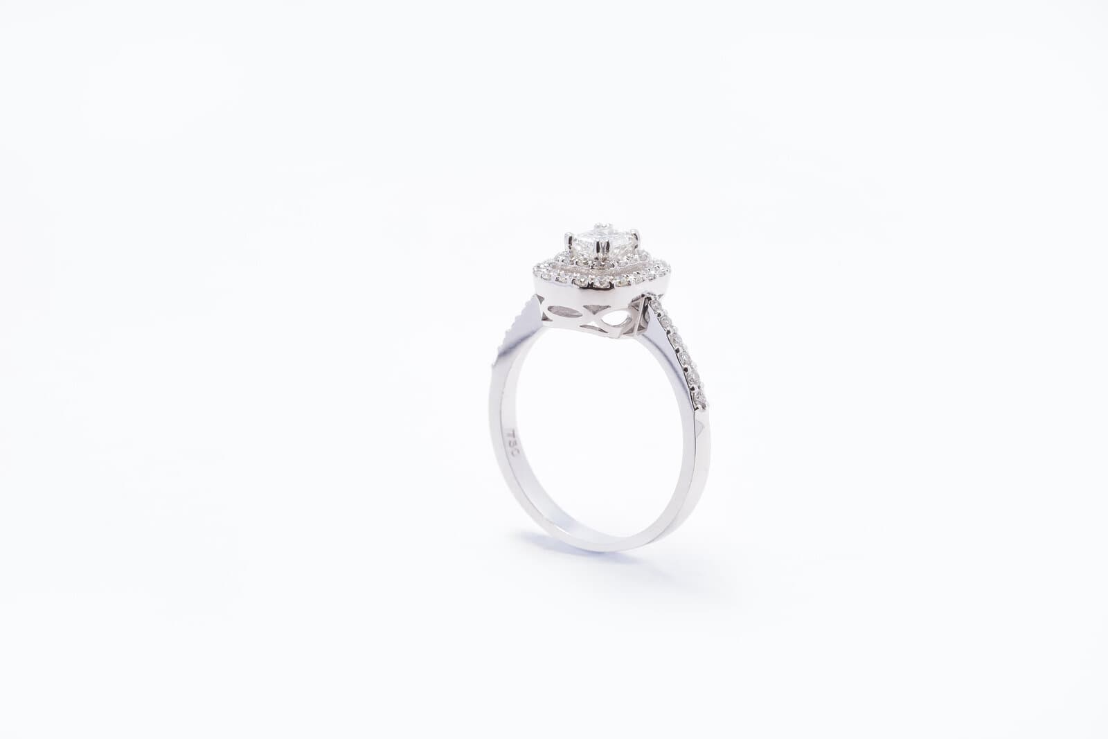 Handcrafted emerald cut shaped diamond with two halos