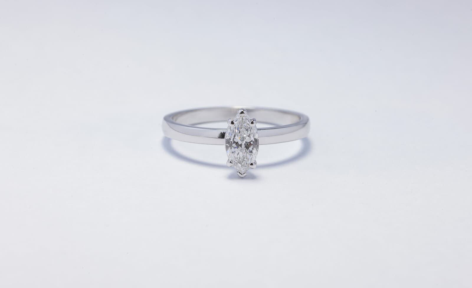 Handcrafted 18k marquise cut solitaire ring with natural diamonds