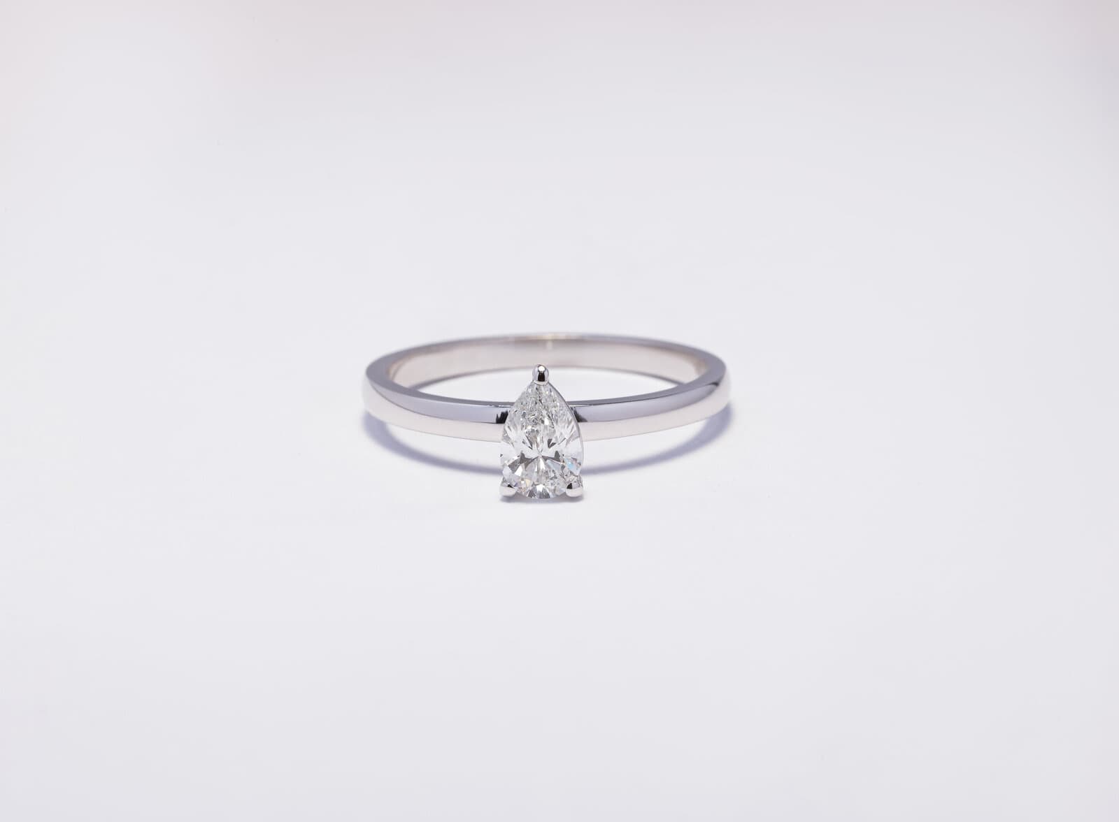 Handcrafted 18k pear shape solitaire ring with natural diamonds